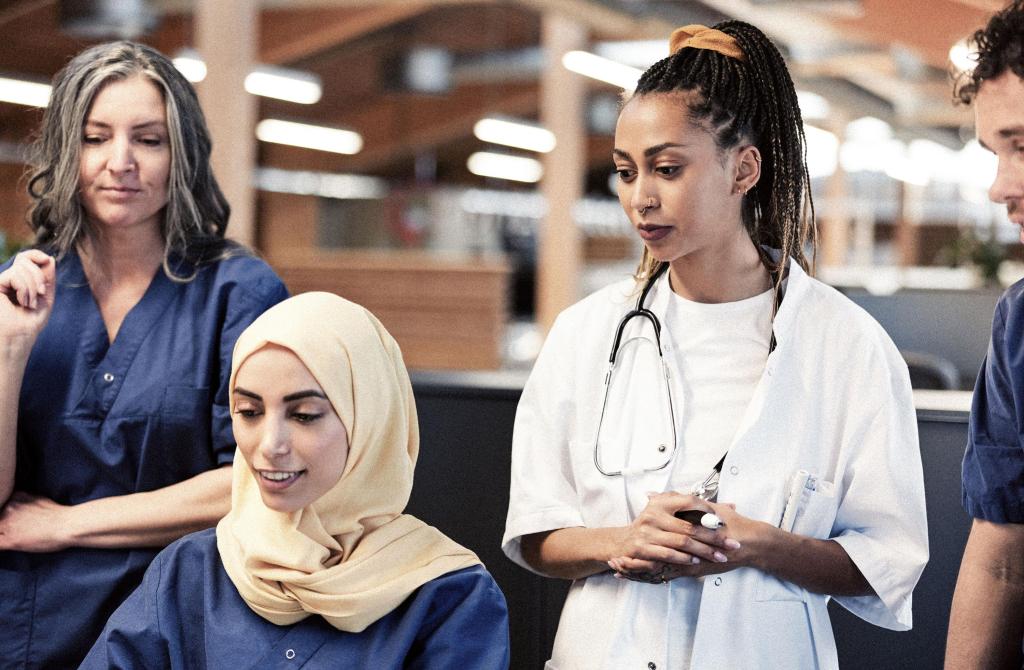 A meeting of a diverse group of doctors and nurses. 