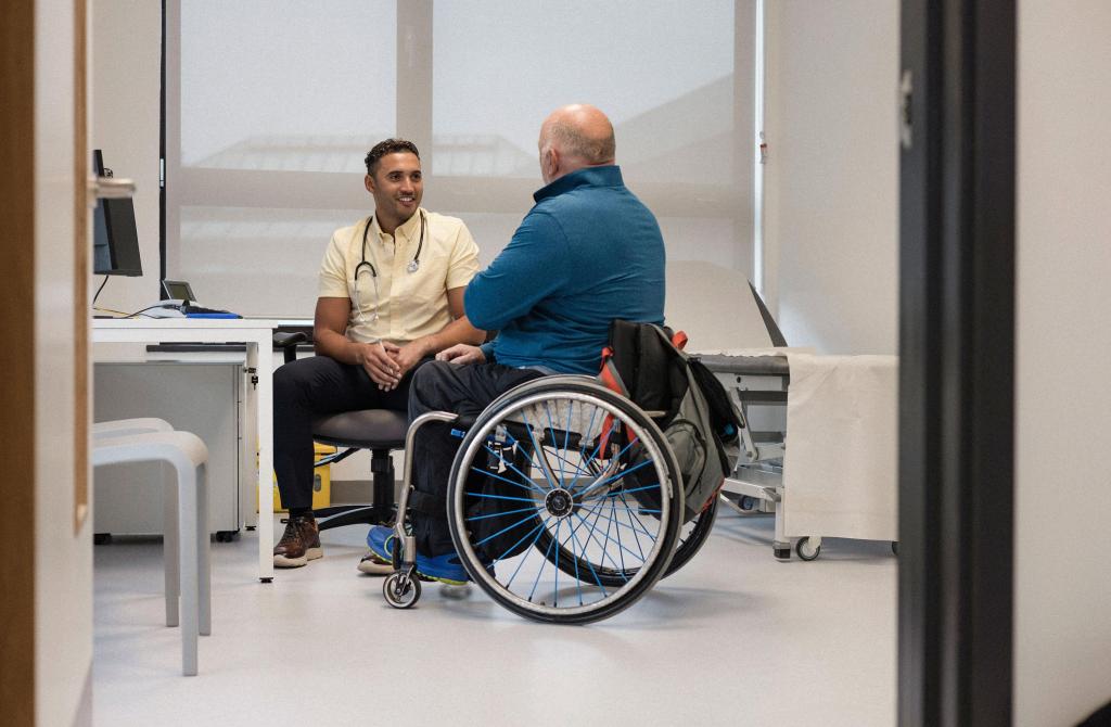 family doctor with patient in wheelchair