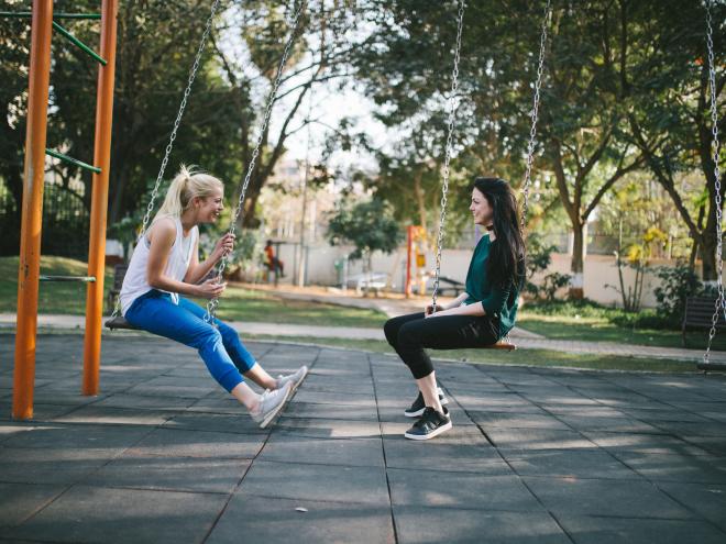 Friends laughing in a park Friends laughing in a park