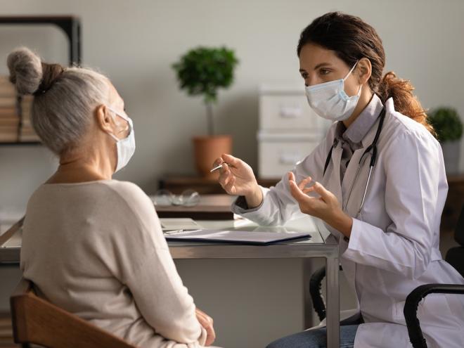 Doctor speaking to elderly patient  Doctor speaking to elderly patient