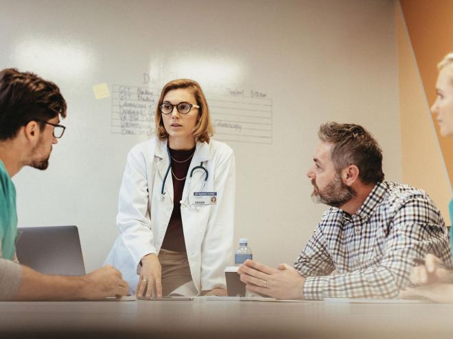 Doctors speaking in a meeting room.