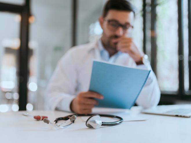 physician-blurry-med-association-advocacy.jpg physician looking at a document