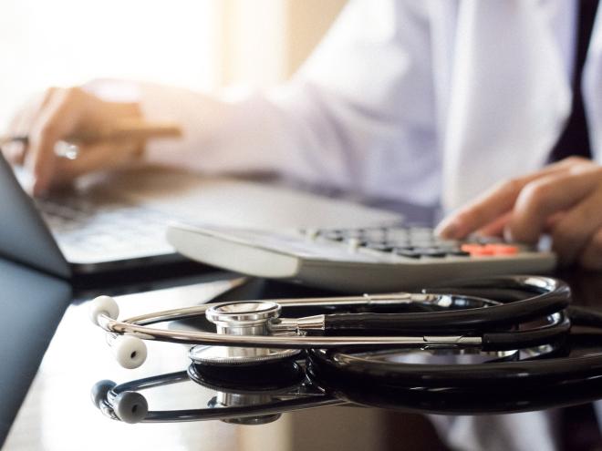 A physician typing on a laptop A physician typing on a laptop