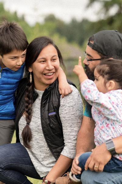 An indigenous family playing in the park. 