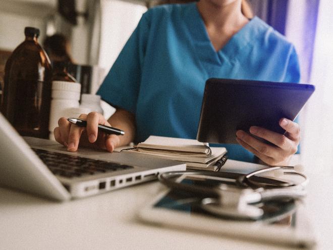 close_up_doctor_on_laptop_with_ipad_adobestock_332813141.jpg close_up_doctor_on_laptop_with_ipad_adobestock_332813141.jpg